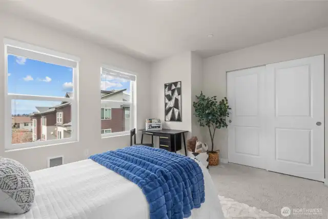 Well-sized second bedroom with plush carpet and make sure to catch the tranquil view of the mountains.