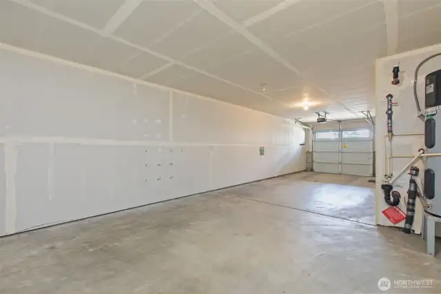 Attached two-car tandem garage with ample storage space and access to the interior and back patio