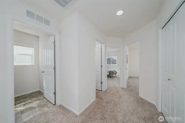 From the top of the stairway looking down the hall, laundry on the left, and 2 bedrooms straight ahead and just past the laundry is the full bath