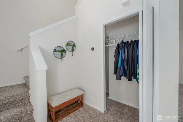 Front Entry Coat Closet, that has extra storage, and the stairs lead to the 1/2 bath and then to the laundry room and bedrooms