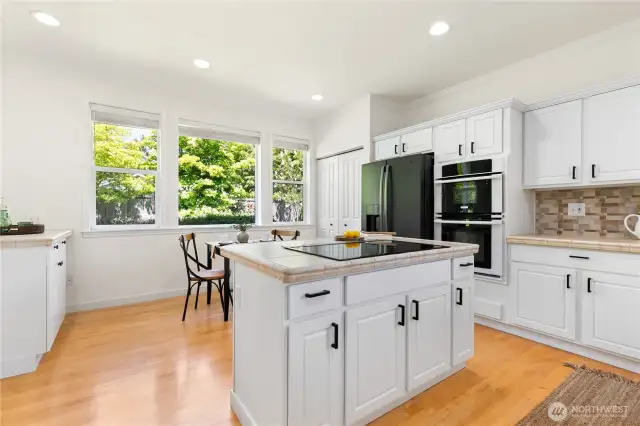Kitchen complete with island, pantry eating nook and timeless white cabinetry in excellent condition.