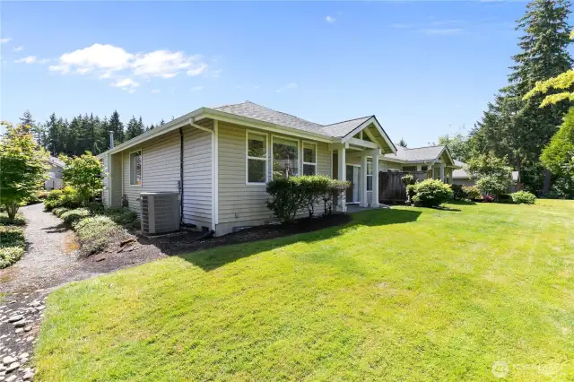 Exterior view of back of home - peep the walking path connecting front/back yards.
