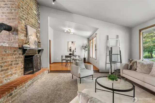 Cozy living room with soft carpet, perfect for relaxing. Enjoy the wood burning fireplace.