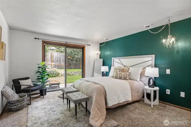 Spacious primary suite with a sliding door to backyard/patio.