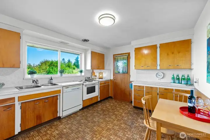 Generous kitchen with plenty of room for a table or island shares the same wonderful views.