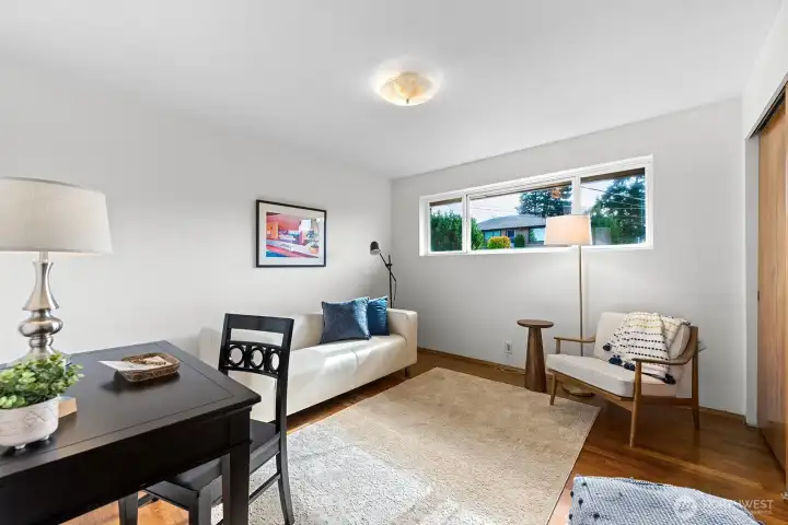 One of three bedrooms, currently staged as a den, has a good size closet and hardwoods.