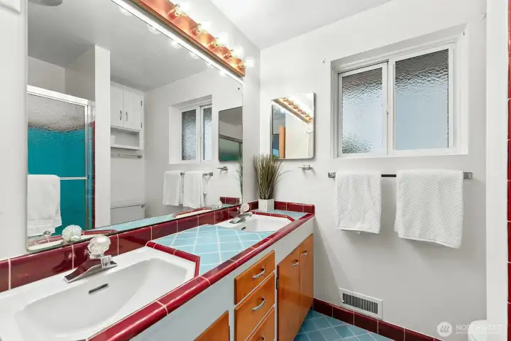 Colorful vintage tile bath serves the main level.