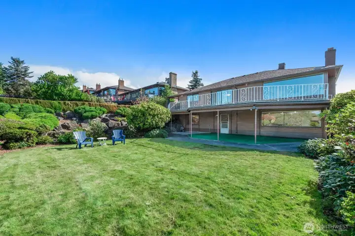 Looking at the back of the house you can see the scale of the deck and patio.