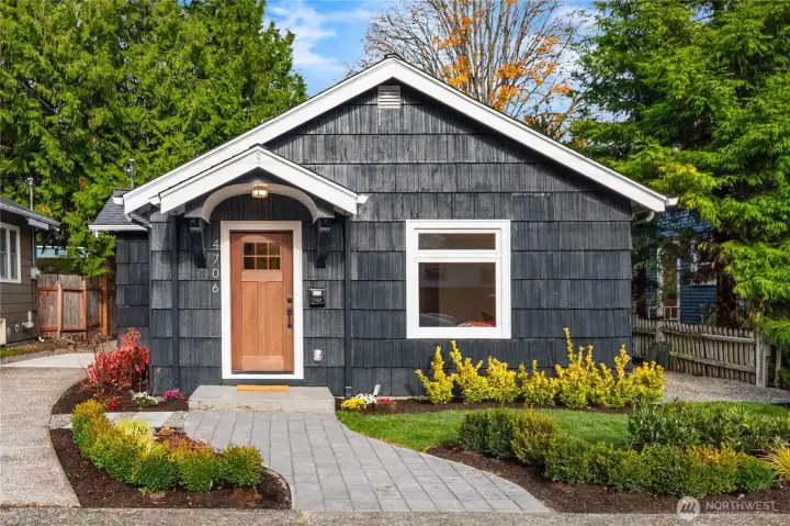 The exterior features all new paint and landscaping including this paver sidewalk and a paver patio in the backyard.
