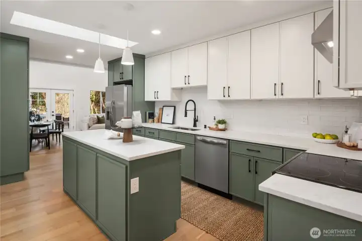 This spacious kitchen will impress with the more-than-ample storage and counter space. A tiled backsplash wraps all the way around.