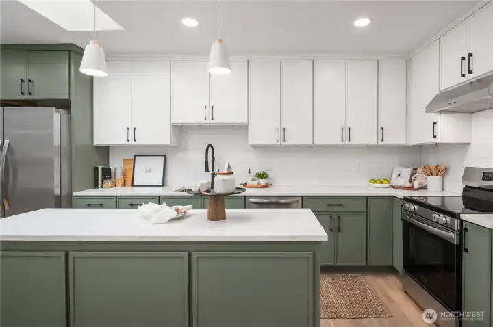 Full height upper cabinets, pendant lights and even an overhead skylight make this a memorable kitchen.