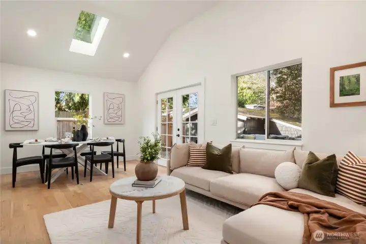 Looking back across the living room the french doors lead to the new deck and backyard as well as the garage.