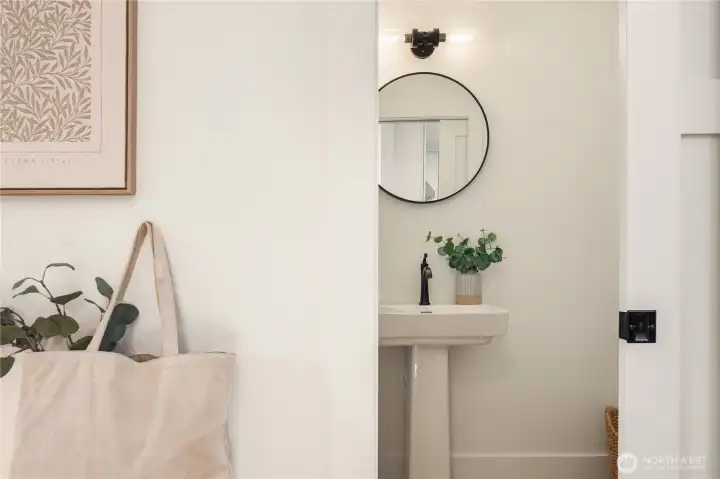 The powder room is one of 3 bathrooms and features a new pedestal sink and all new fixtures.
