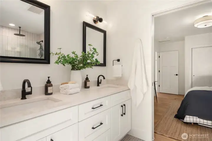 This gorgeous bath features private entrance from both main floor bedrooms with extensive tile work and designer fixtures.