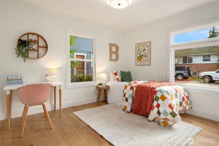 The second of three bedrooms features 2 windows and a large closet with custom installed closet shelving.