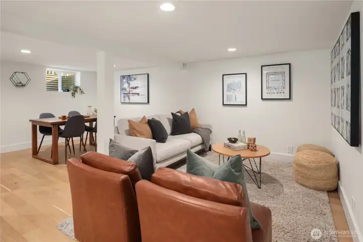 Downstairs is this rec room that is equally gorgeous with the same engineered wood floors, recessed lighting and new millwork.