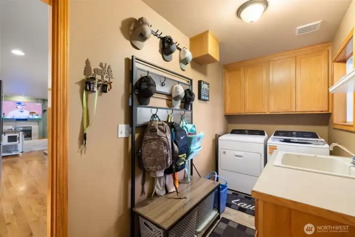 Utility room with sink and added functional space.