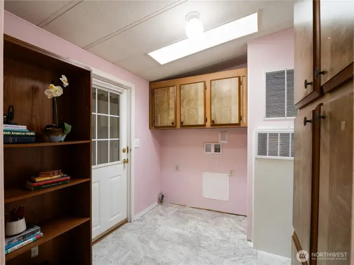 The laundry room has storage and room for full size washer and dryer.