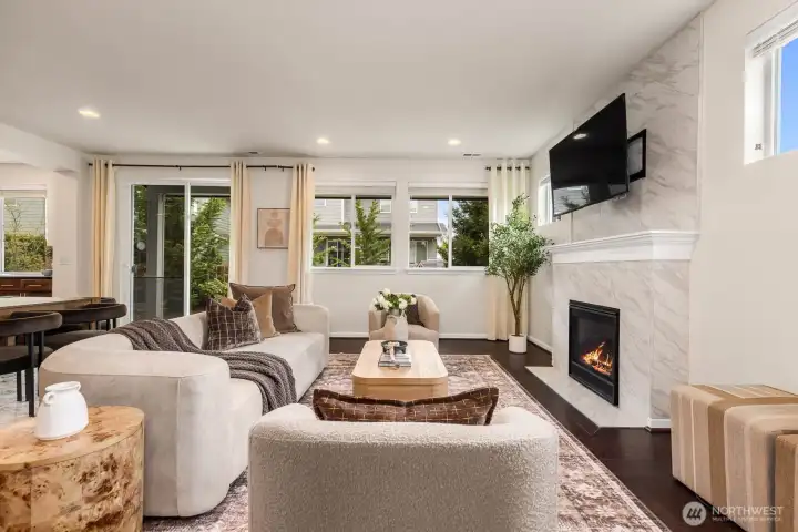 Living room complete with gas fireplace and outdoor back patio access