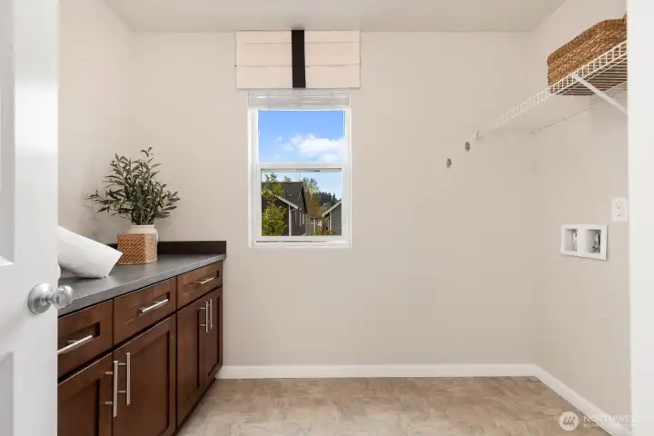 Utility room with additional storage and countertop space