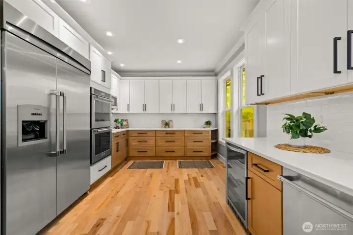 Incredible counter top space and abundance of cabinet storage with updated appliances and wine/beverage fridge.