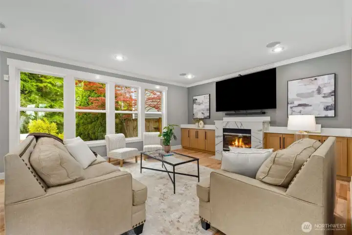 Comfortable living room with ample natural light provided by large windows.