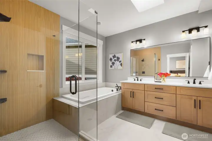 Get your day started in this luxuriously updated primary bathroom. It features modern fixtures, ample counter space, and a soothing color palette, creating a serene and inviting space for your morning routine.