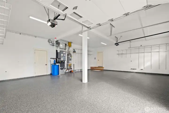 This meticulously maintained garage offers an abundance of space, boasting a pristine and inviting environment. The highlight is undoubtedly the newly installed, durable epoxy flooring, which not only enhances the aesthetic appeal but also provides a remarkably easy-to-clean and long-lasting surface, perfect for any garage enthusiast or homeowner.