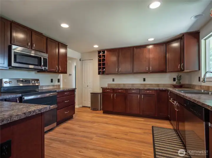Look at this beautiful spacious, open kitchen with pantry & an abundance of countertop space.