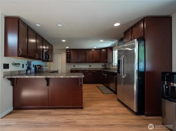 View of kitchen with eating space from the dining area.