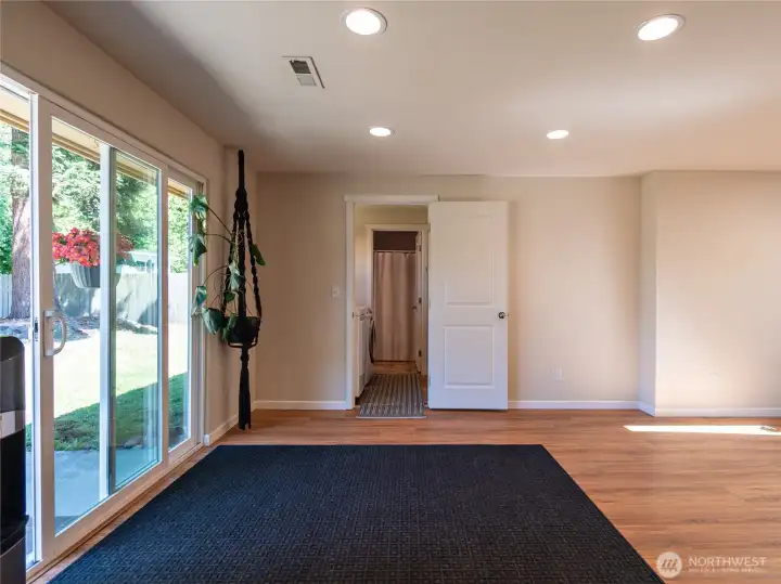 View from the Kitchen with the sliding door on the left to the backyard patio with the utility room and 2nd bath straight ahead.