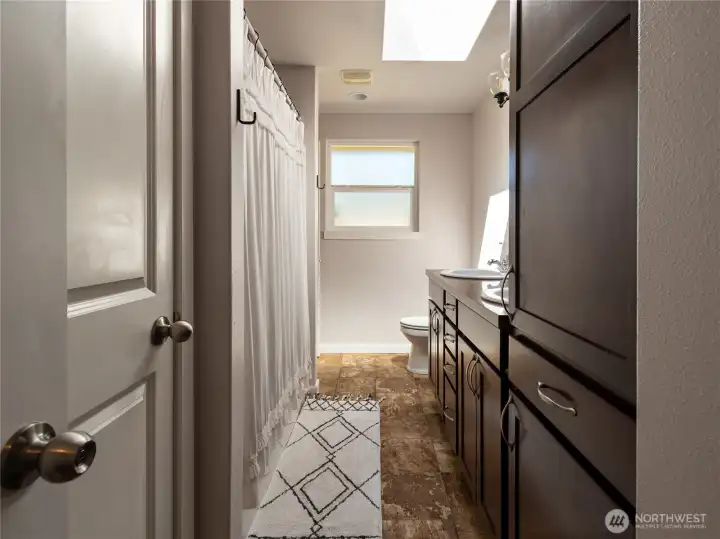Primary bath that features a secondary door for hallway access.