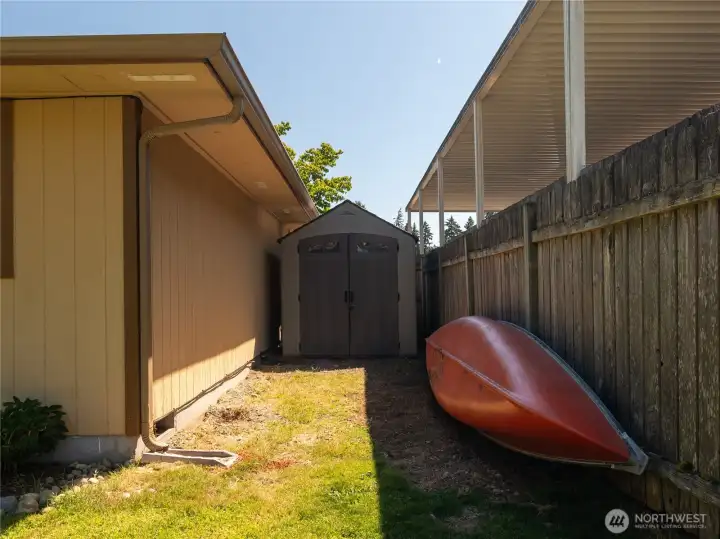 Shed tucked away in the backyard for toys & lawn tools..