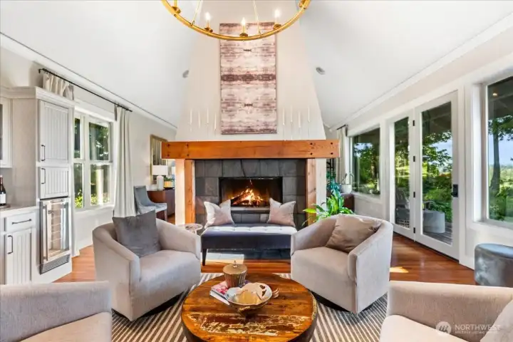 Stunning see-through fireplace connecting living and dining rooms.