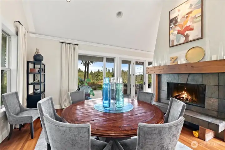 Elegant dining room warmed by a stunning see-through fireplace.