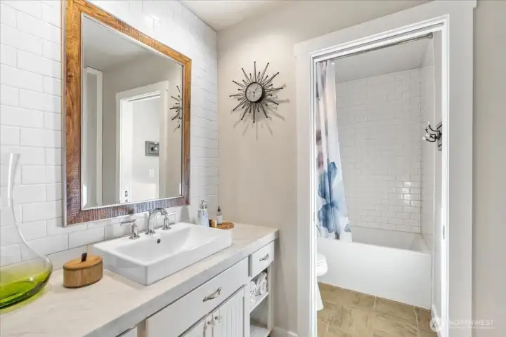 Convenient full bath with Subway tile located near main-floor bedrooms.