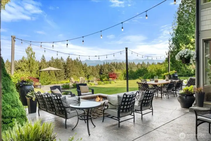 Large outdoor gas fireplace with mountain views.