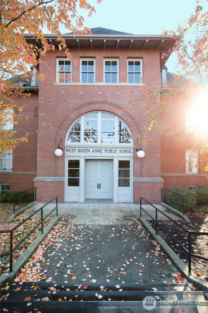 The building's grand central entrance still carries the quiet dignity of its educational past, welcoming residents through the same architectural composition that greeted generations of Seattle students.