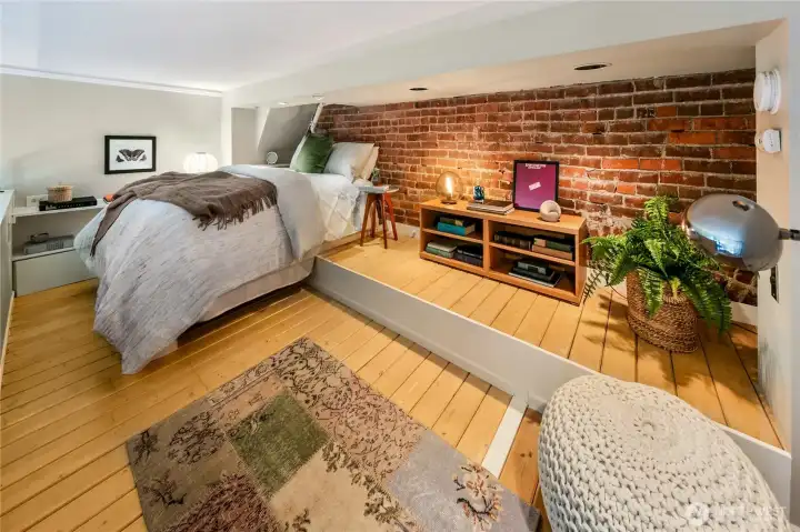 Exposed brick masonry, warm wood flooring and historic architectural elements reveal layers of craftsmanship and history impossible to replicate today.