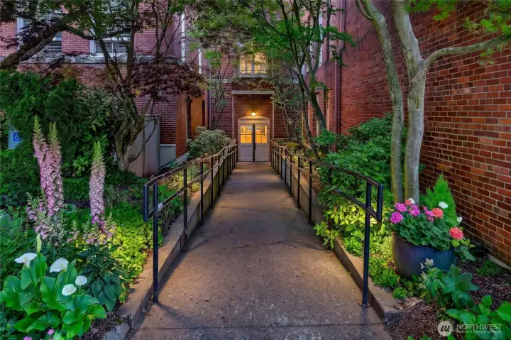 Landscaped pathways and mature plantings create a welcoming arrival experience throughout the school's 1.6-acre campus setting.