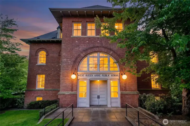 The building's grand central entrance still carries the quiet dignity of its educational past, welcoming residents through the same architectural composition that greeted generations of Seattle students.