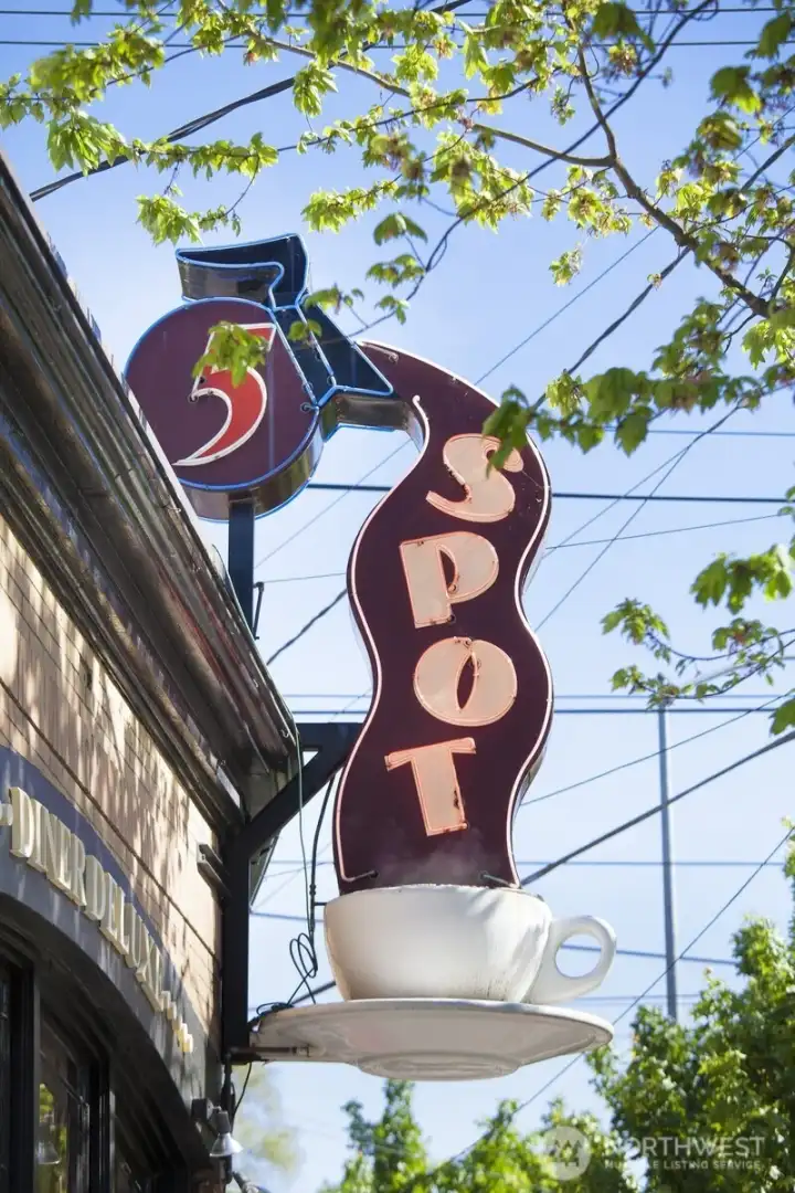The iconic 5 Spot sign recalls generations of neighborhood gathering, preserving a visual link to Queen Anne's commercial and social history.