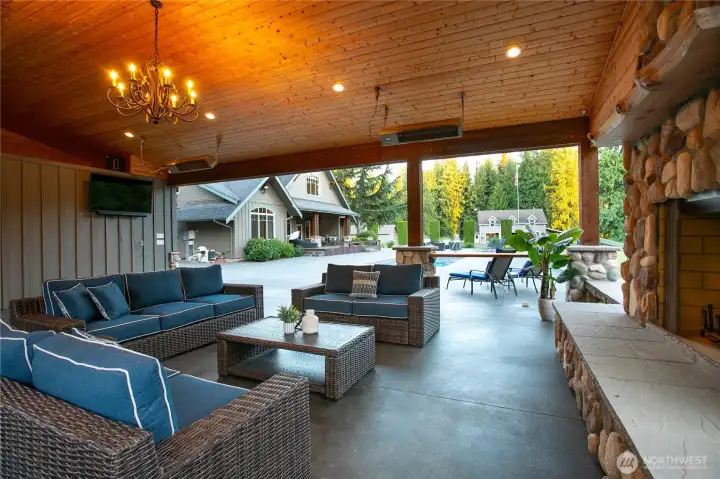 The outdoor living room is complete with a stone fireplace, heaters, and bar area—creating a private resort setting ideal for year-round enjoyment. The outdoor living room is complete with a stone fireplace, heaters, and bar area—creating a private resort setting ideal for year-round enjoyment.