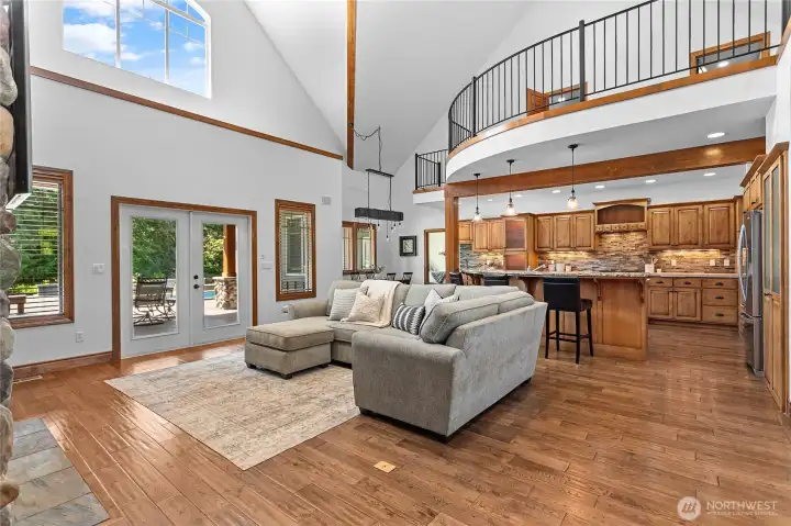 French doors open to the covered patio with extended patio beyond including a separate firepit area, outdoor covered living space with its own wood burning fireplace and multiple lounging areas. French doors open to the covered patio with extended patio beyond including a separate firepit area, outdoor covered living space with its own wood burning fireplace and multiple lounging areas.