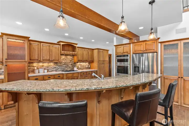 Beautiful gourmet kitchen featuring expansive bar seating, abundant cabinetry, and timeless design. Beautiful gourmet kitchen featuring expansive bar seating, abundant cabinetry, and timeless design.