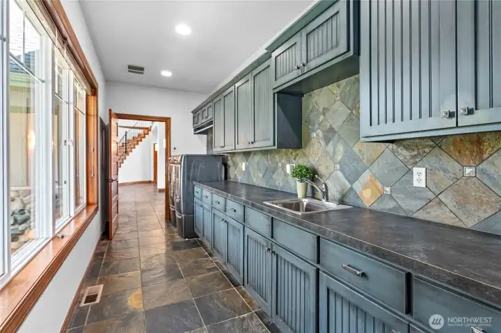 Expansive laundry room with washer, dryer, sink and 3/4 bath (not pictured) Expansive laundry room with washer, dryer, sink and 3/4 bath (not pictured)