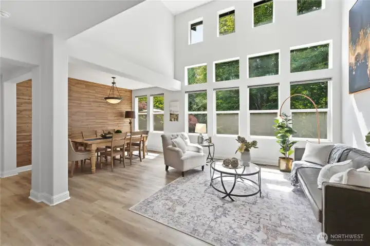 Light-filled windows and elevated ceilings bring an airy, elegant feel to the formal living and dining areas. Light-filled windows and elevated ceilings bring an airy, elegant feel to the formal living and dining areas.