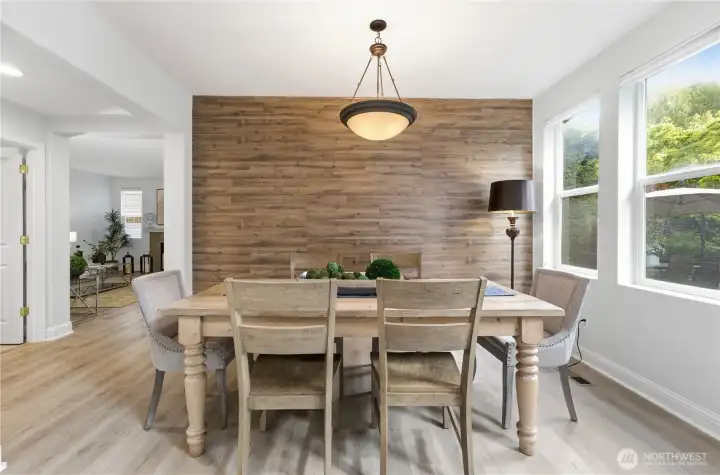 A bright, inviting dining room beside the formal living area, with wall accent in rich wood textures. A bright, inviting dining room beside the formal living area, with wall accent in rich wood textures.