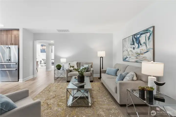 A warm family room next to the kitchen, you can see the living and dining spaces from in front of the fireplace A warm family room next to the kitchen, you can see the living and dining spaces from in front of the fireplace
