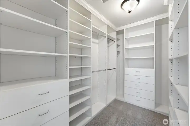 Generous walk-in closet with built-in organizers, offering exceptional storage for the primary suite. Generous walk-in closet with built-in organizers, offering exceptional storage for the primary suite.